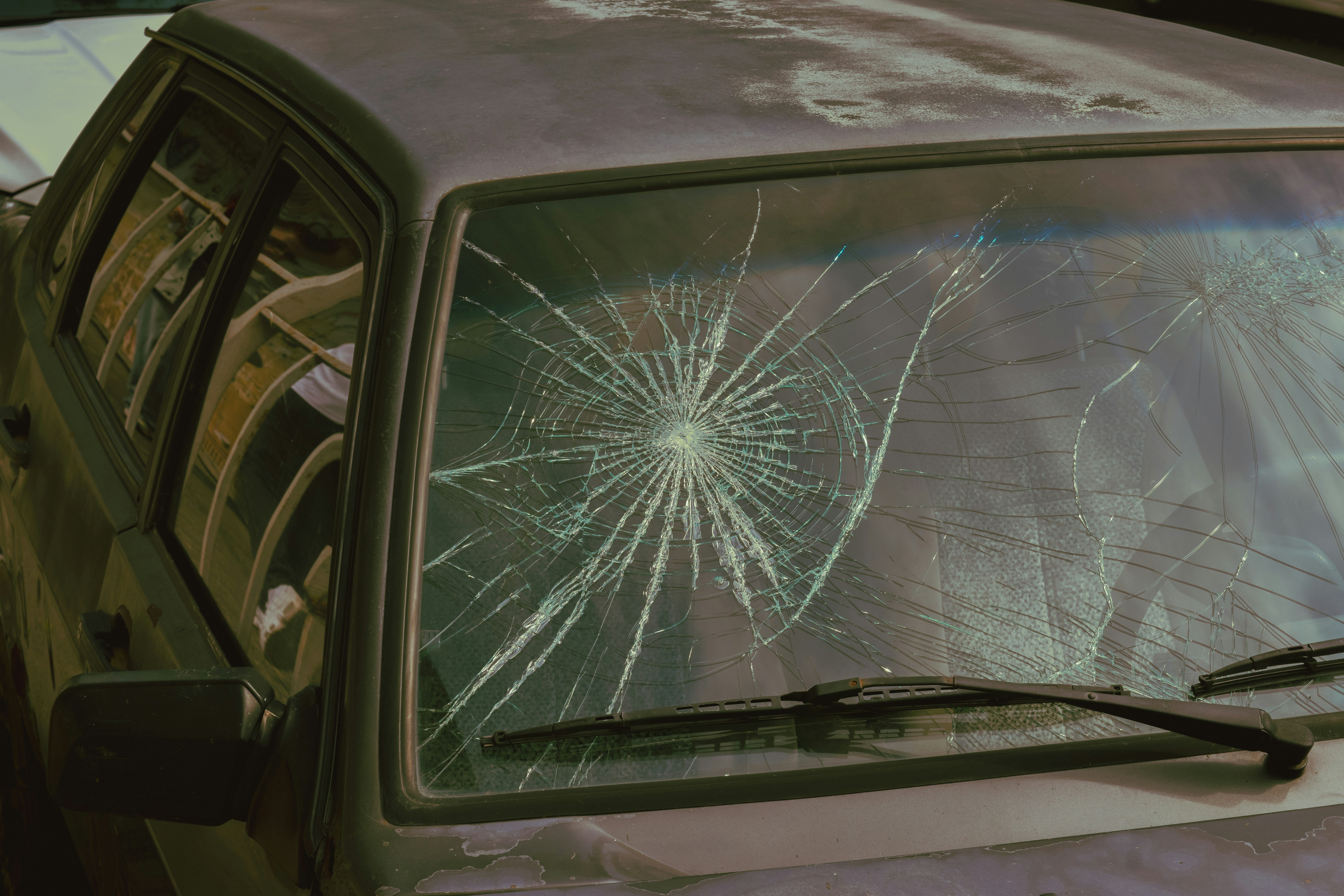 Close-up of a shattered windshield with spider-crack damage before chip repair in Kennewick, Richland, or Pasco WA